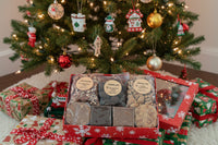 Assorted pecans and cookies in a decorative box on a wooden surface