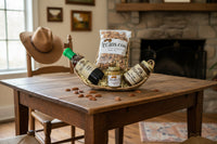 Pecan Syrup, pecan honey butter, jalapeno peach preserves and raw pecans in a cowboy hat shaped wicker basket