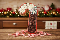 milk and white chocolate pecans in a wicker candy cane shaped basket